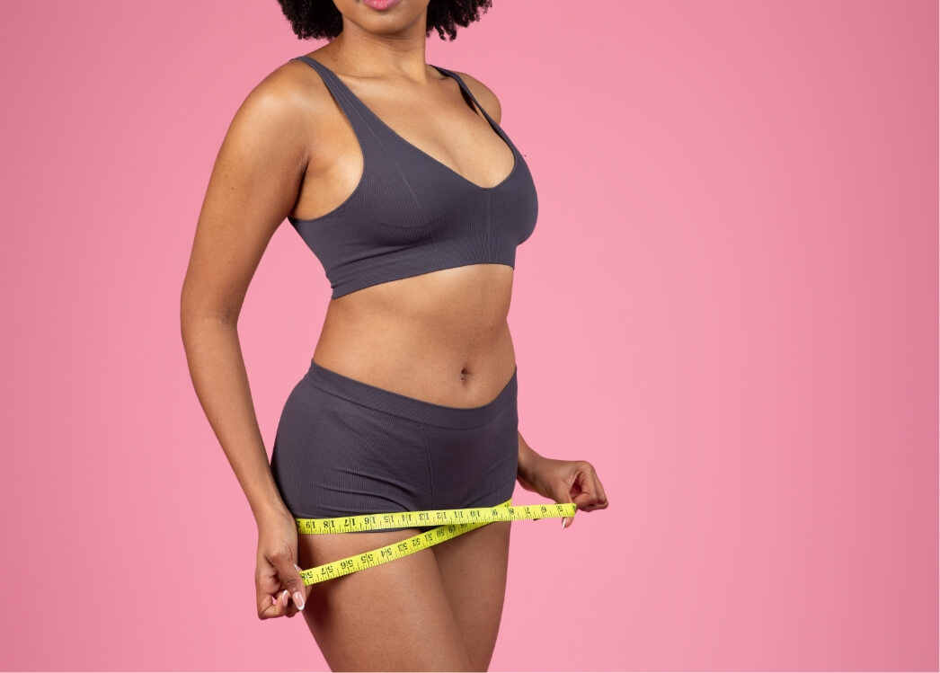woman-measuring-waist-with-a-bright-yellow-tape-me-2024-04-08-20-34-40-utc (1)